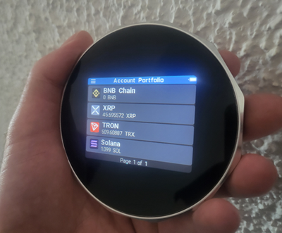 SecuX V20 hardware wallet in hand displaying wallets for BNB Chain, XRP, Tron, and Solana.