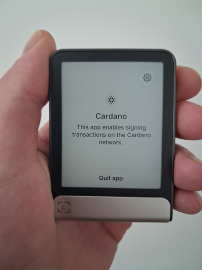 In my hand Ledger Flex displaying Cardano app