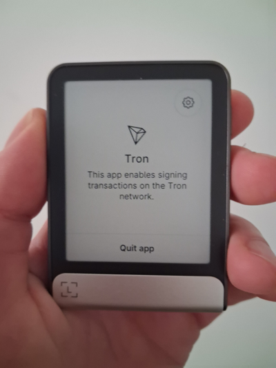 In my hand Ledger Stax device displaying Tron app